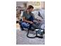 Un homme nettoie le canapé avec le nettoyeur de tapis et moquettes SILVERCREST®.