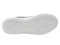 Semelle blanche d'une chaussure de sport avec un motif ondulé.