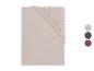Drap-housse beige avec élastique, présenté plié, avec des échantillons de couleur.