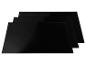 Trois dessous-de-plat noirs pour casseroles chaudes.