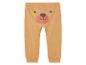 Pantalon bébé beige avec un motif d'ours.