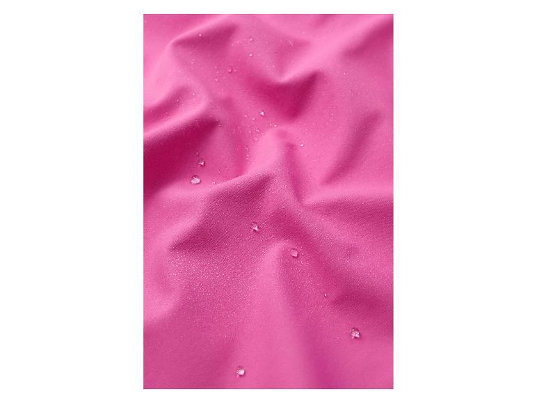 Gros plan de tissu rose imperméable avec des gouttelettes d'eau sur sa surface.