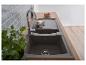 Évier de cuisine gris moderne avec robinet chromé, plan de travail en bois et crédence carrelée grise.
