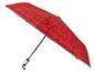Parapluie rouge avec un motif géométrique de cercles, triangles et carrés.