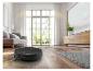 Robot aspirateur nettoyant un parquet dans un salon lumineux.