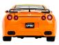 Une voiture jouet Nissan GT-R orange avec un aileron