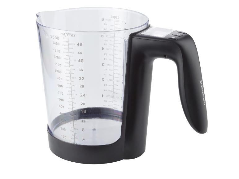Verseuse doseuse numérique avec poignée noire et graduations claires pour millilitres, onces liquides et tasses.