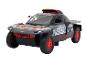 Un modèle de voiture de rallye Audi e-tron noir avec des jantes rouges.