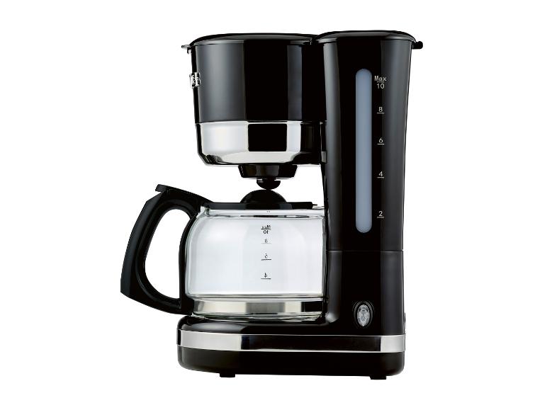 Cafetière noire avec verseuse et échelle de mesure, sur fond blanc.