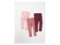 Trois leggings pour enfants dans des tons rose et bordeaux.