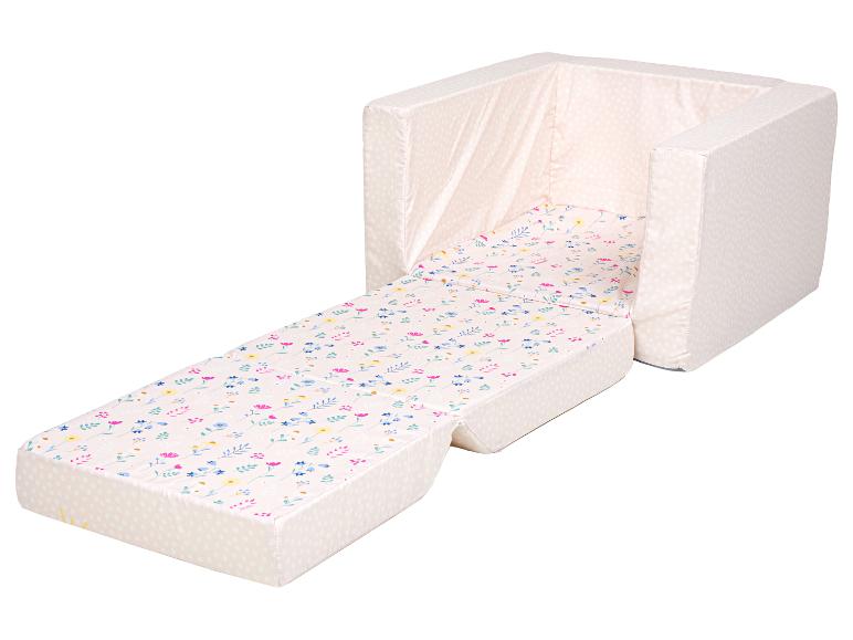 Fauteuil pour enfant rose à motif floral, dépliable en lit.