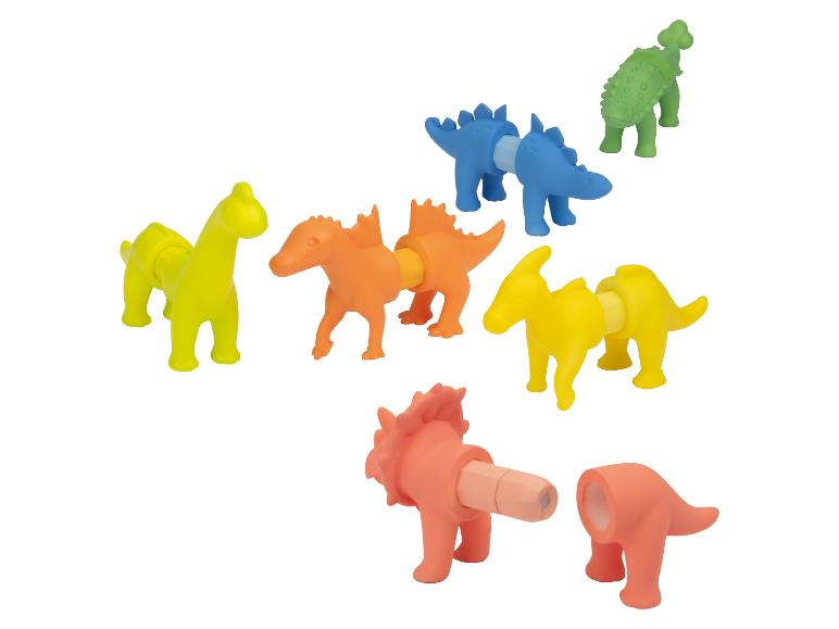Dinosaures jouets colorés et assemblables dans les tons jaune, orange, bleu et vert.