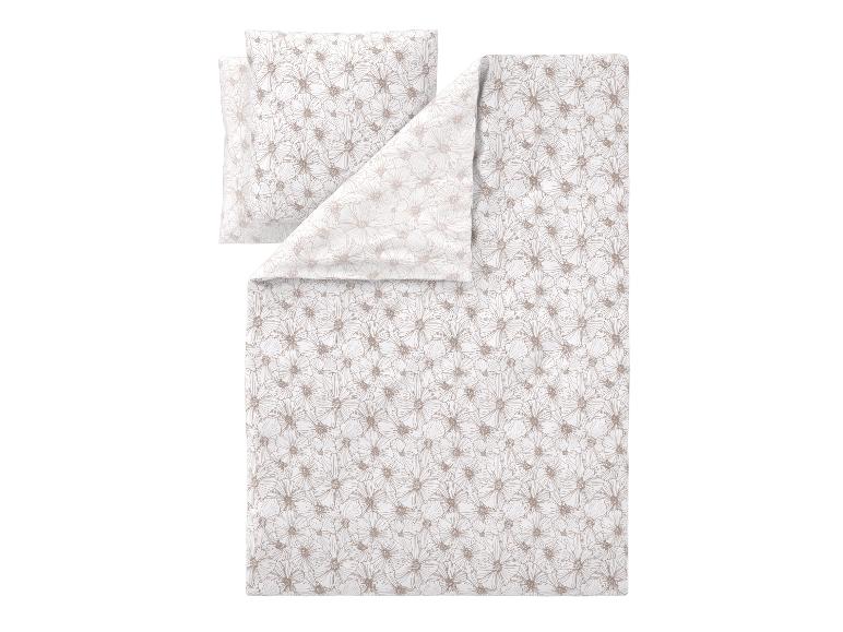 Parure de lit avec taie d'oreiller et housse de couette à fleurs beiges.