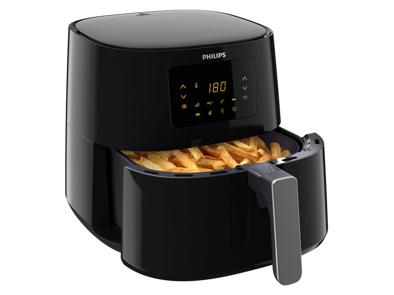 Une friteuse à air Philips noire avec des frites.