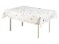 Une table blanche avec une nappe à fleurs.