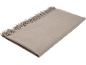 Couverture beige à franges, soigneusement pliée.
