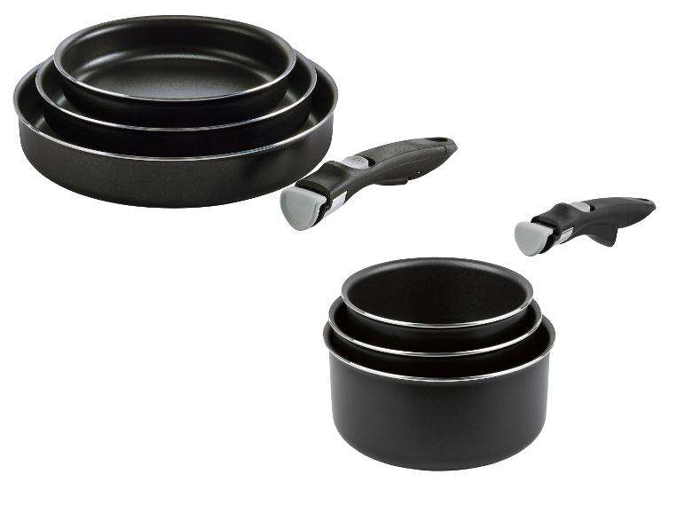 Ensemble de poêles et casseroles noires empilables avec poignées amovibles.