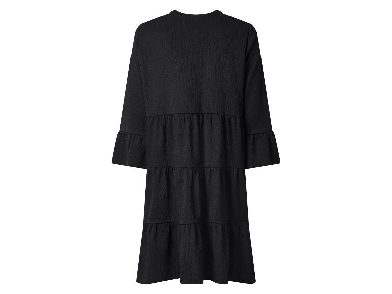 Robe noire femme à manches longues avec jupe à volants.