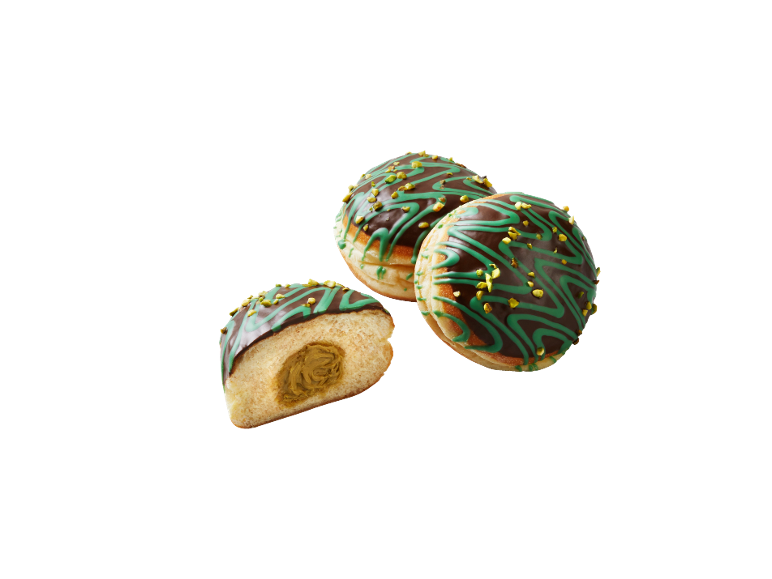 Beignets fourrés avec glaçage au chocolat, décoration verte et pistaches hachées.