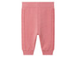 Pantalon de jogging rose avec des bandes côtelées sur les côtés.