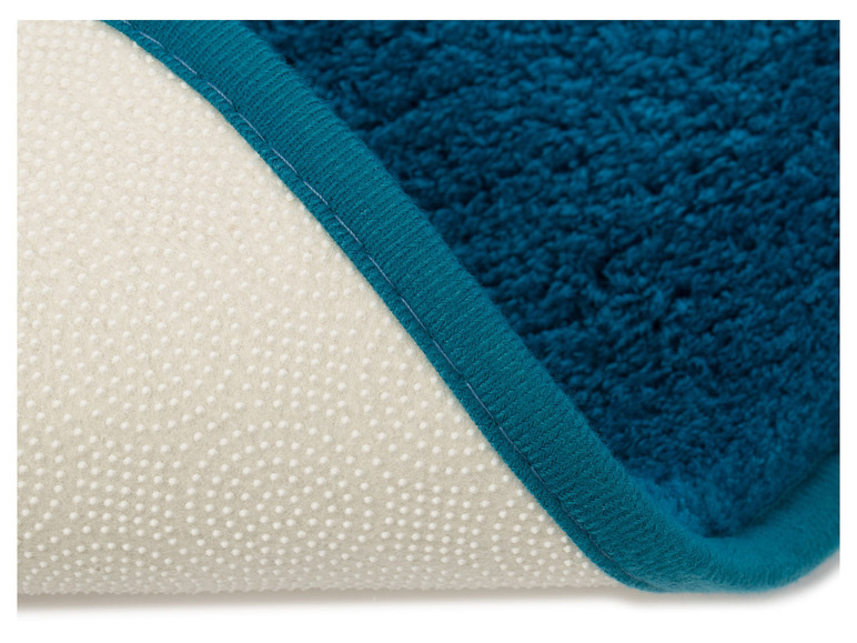 Tapis de bain bleu avec dos antidérapant.