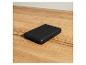 Une powerbank noire de la marque TRONIC sur une table en bois.