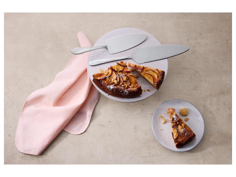 Tarte aux pommes avec pelles à tarte sur une assiette et serviette rose.