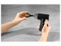 Un pistolet de massage Vitalmaxx noir avec un accessoire en forme de U.