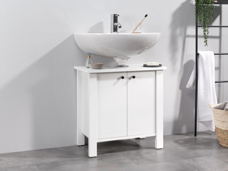 Meuble de salle de bain blanc avec lavabo et deux portes.