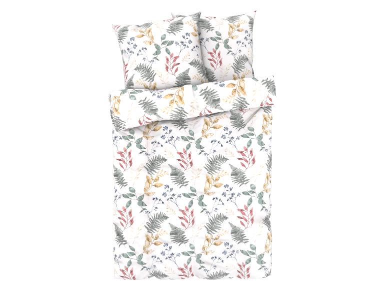 Un ensemble de literie blanc avec un motif botanique.