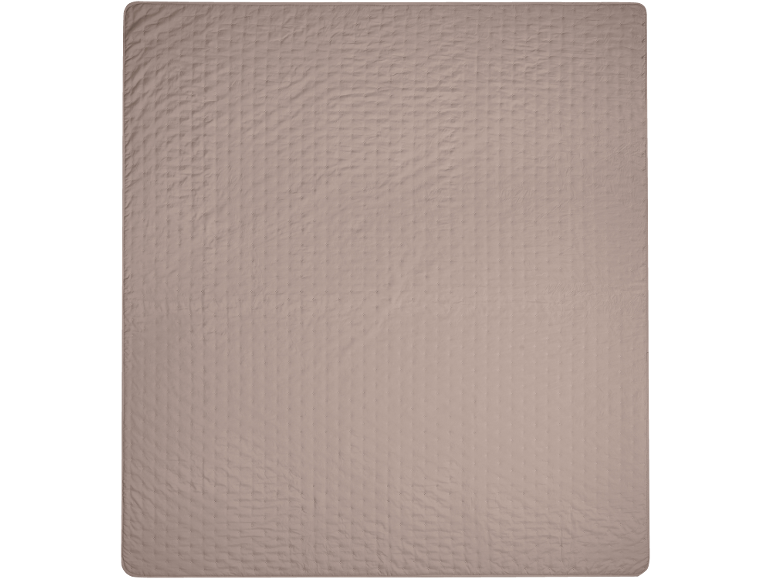 Gros plan d'une couverture matelassée de couleur marron clair ou beige