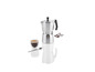 Une cafetière en argent avec une tasse de café et des grains de café.