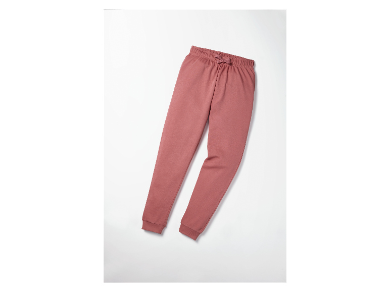 Pantalon de jogging rose sur fond blanc.