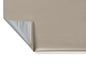 Une toile de tente beige et argentée, pliée avec un ourlet.