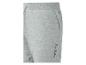 Pantalon de jogging gris avec cordon de serrage, poches et texte décoratif.