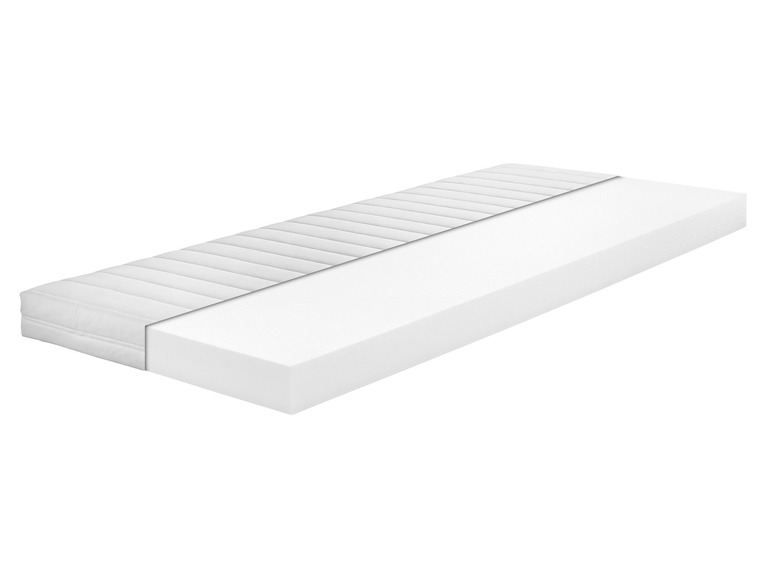 Un matelas blanc avec un dessus capitonné.