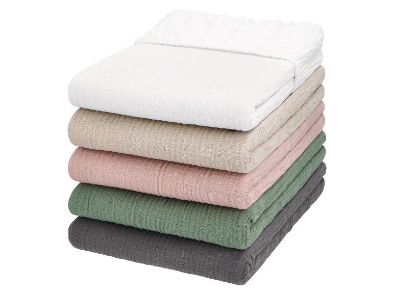 Pile de draps-housses en mousseline de coton de différentes couleurs