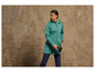 Une femme portant une veste softshell verte et des jumelles.