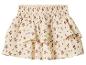 Mini-jupe à volants crème avec motif floral violet et taille smockée.