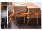Deux armoires en bois avec des pieds attachées à une remorque avec des sangles oranges.