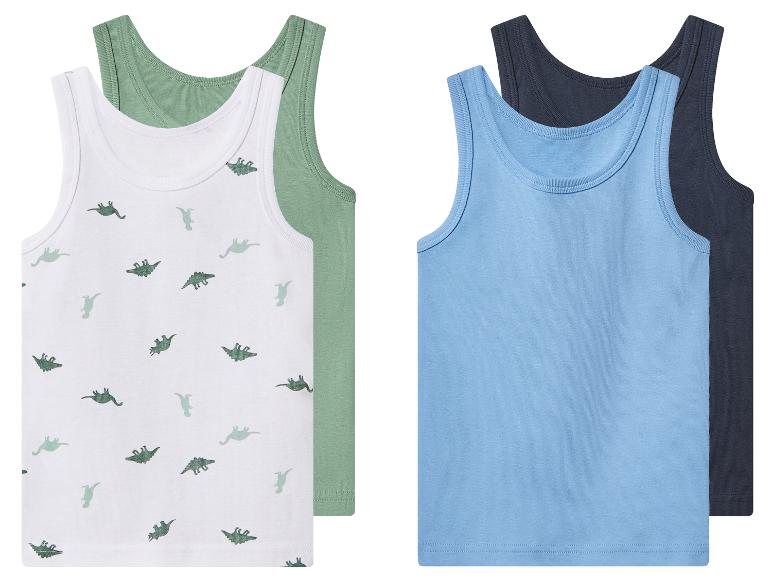 Lot de 4 débardeurs pour enfants : deux blancs à imprimé dinosaures et deux unis bleu et bleu foncé.