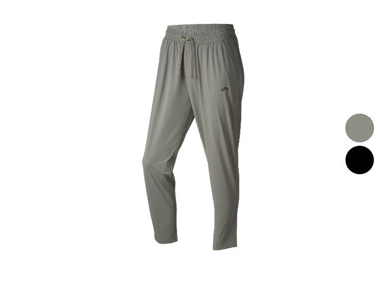 Pantalon de sport gris avec taille élastique et cordon de serrage, également disponible en noir.