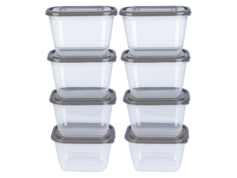 Une pile de six récipients en plastique transparents avec des couvercles gris.