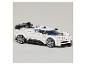 Voiture de sport jouet blanche en blocs de construction avec des accents noirs et des vitres bleues.
