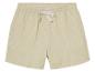 Shorts beige à pois blancs.