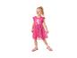 Fille souriante en robe rose avec imprimé cochon et baskets roses