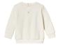 Un sweat à manches longues blanc avec des boutons pour bébés.