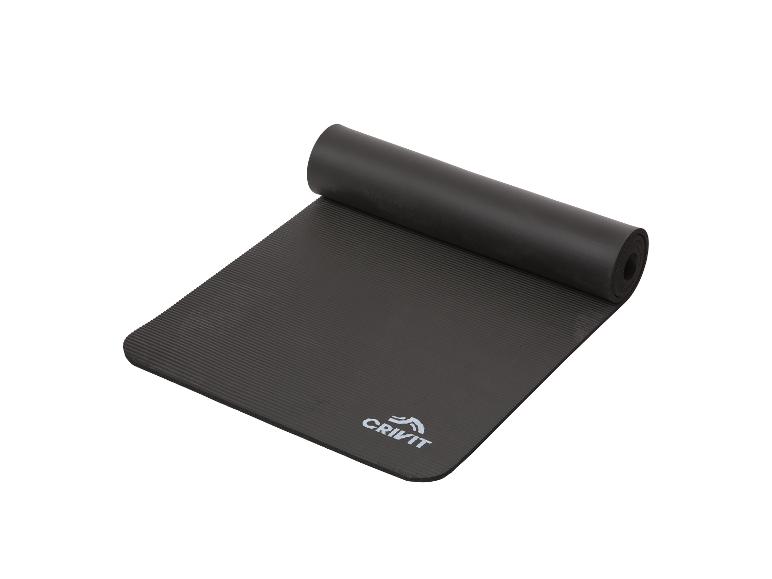 Tapis de yoga noir Crivit, partiellement enroulé