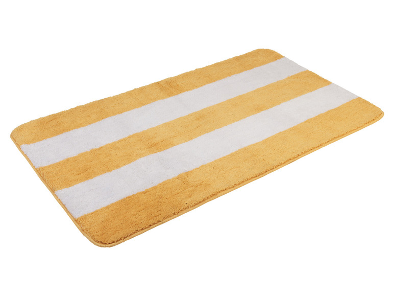 Un tapis de bain jaune et blanc à rayures.