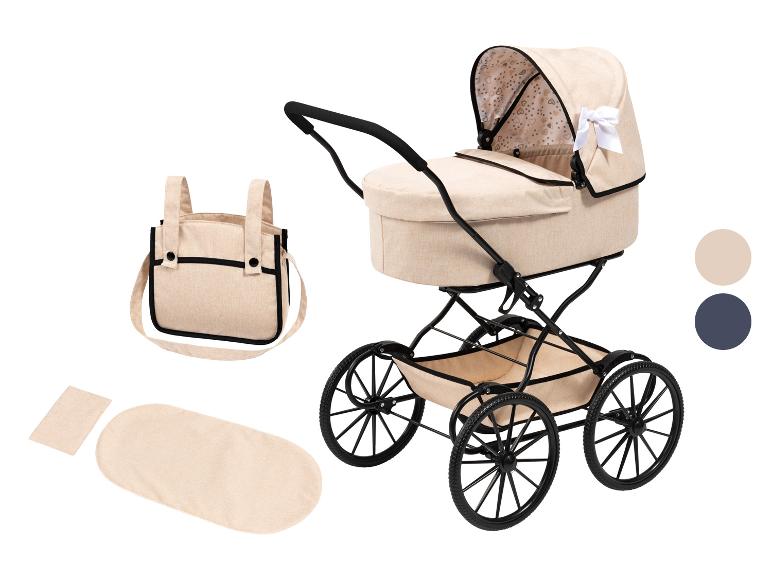 Poussette de poupée beige avec accessoires: sac à langer, matelas et oreiller.
